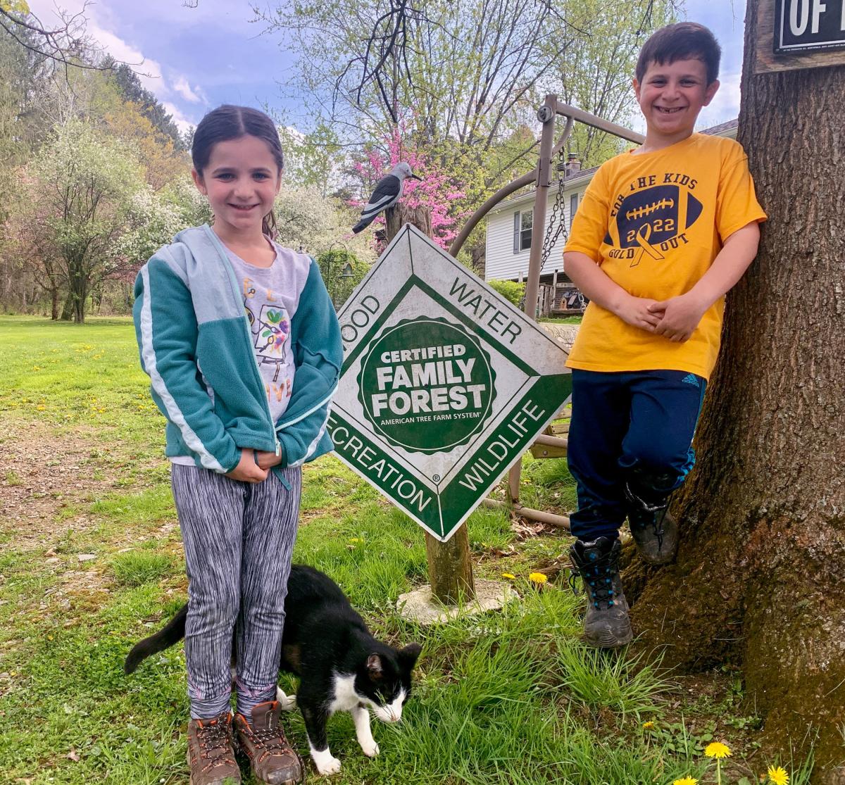 Ziva, Ari and Cat show off Trailing Pines Tree Farms’ Certified Family Forest designation.