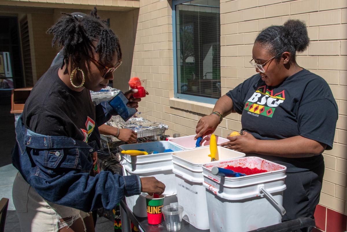 BSU Vice President Chyanna L. Galagarza, a human services & restorative justice student from Williamsport, scoops water ice. While she didn’t make the water ice, Galagarza and her mother made the hot food on the complementary buffet: beef patties, rice and fried chicken.