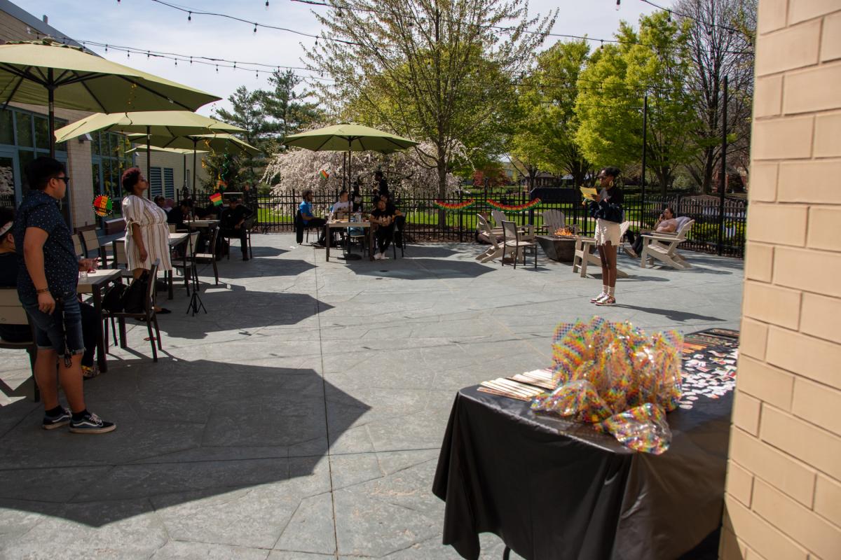 Gathering in the sun, attendees listen as Jashonda S. Scott, of Williamsport, reads a well-loved poem. Scott, of Williamsport, is studying human services & restorative justice.