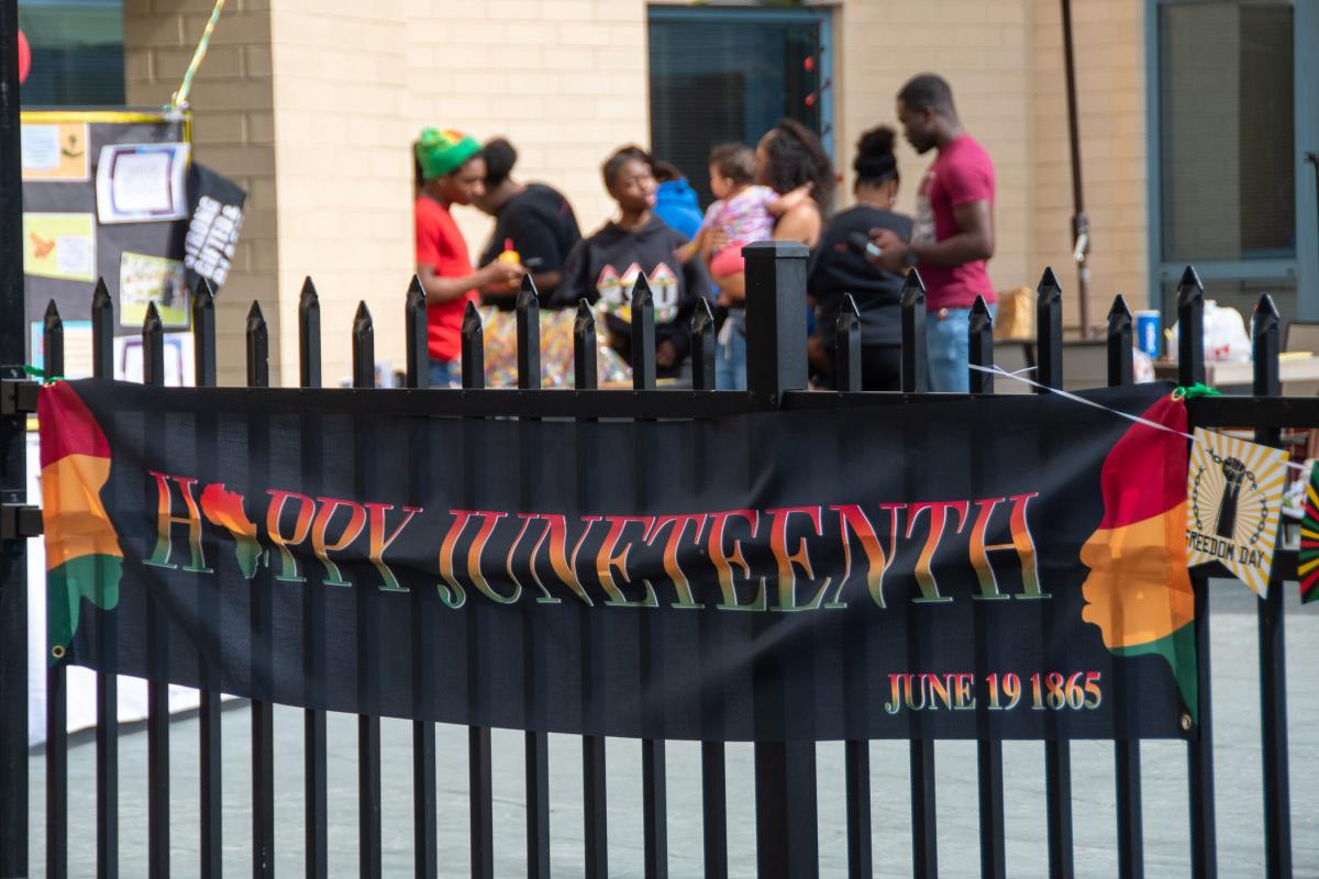 A banner welcomes the community to celebrate.