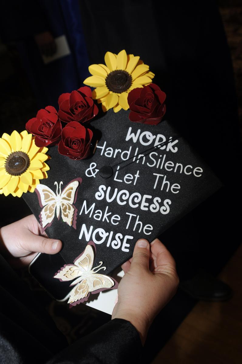 Lauryn A. Stauffer's cap reveals the secret to her campus leadership, as well as her completion of a four-year degree in automation engineering technology: robotics & automation.
