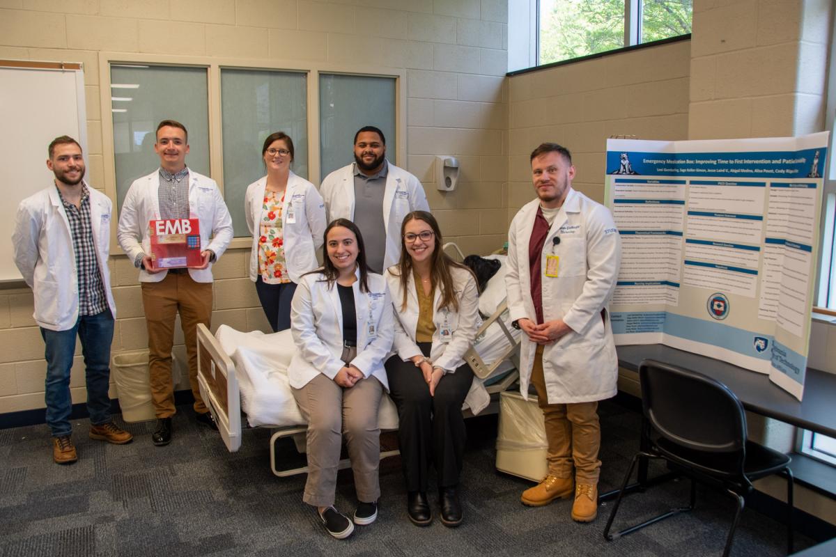 Back row (from left): Cody A. Ripka; Jesse D. Laird V, holding a proposed emergency medication box; Alisa Poust; and Sage X. Keller-Simon. Front row (from left): Abigail Medina, Lexi K. Gemberling and Isa Rizzo.