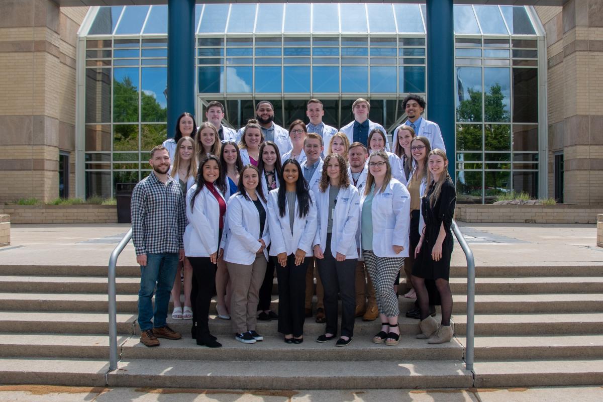 The bachelor’s degree nursing major’s May graduating class gathers in front of their Breuder Advanced Technology & Health Science Center home base.