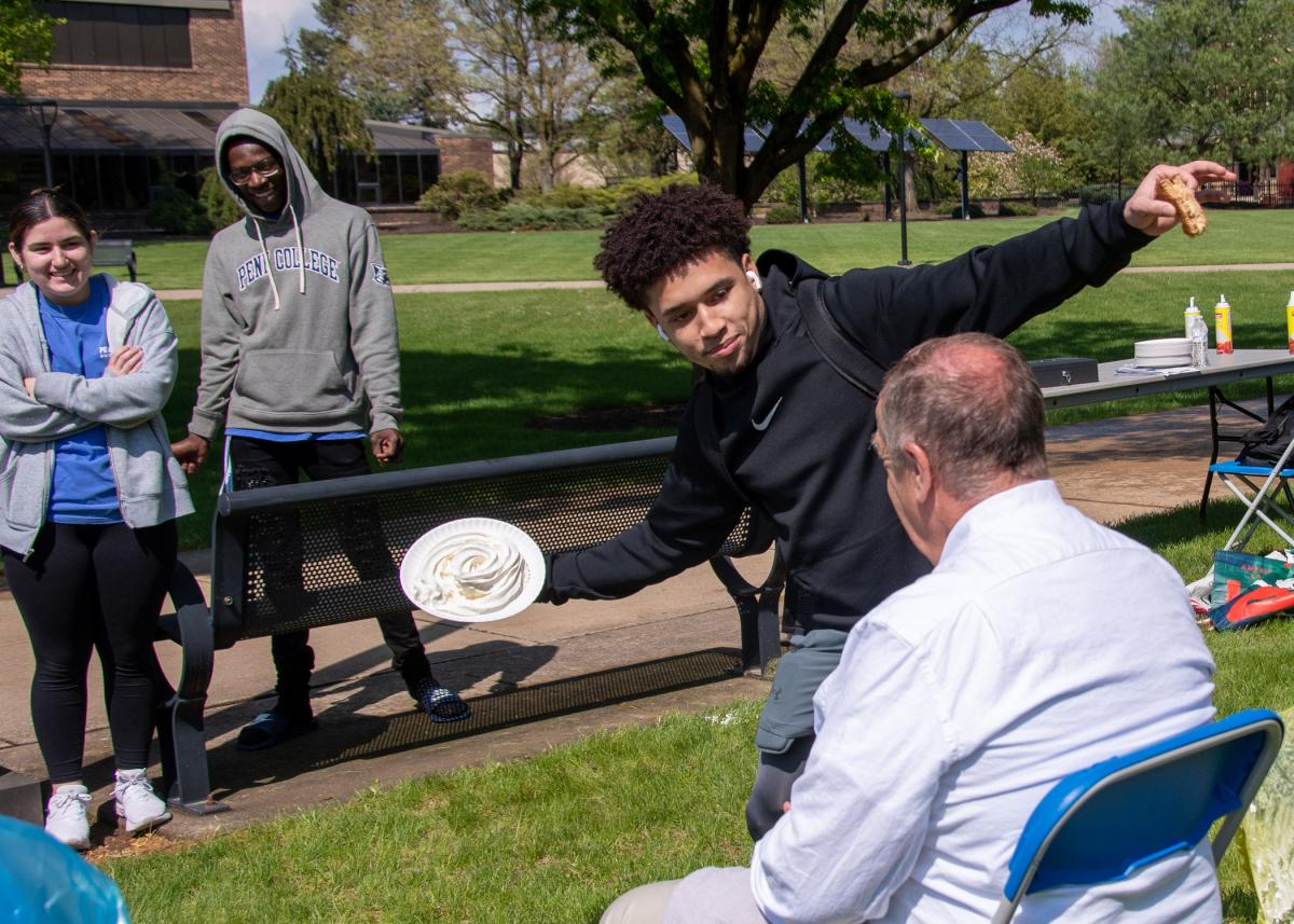 Darrius M. Williams, pursuing degrees in culinary arts technology and applied management, takes a slow-motion approach as he prepares to smother Moff.