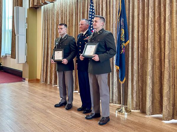 Roe (left) and Laird are awarded DMS honors by Lt. Col. John C. Acosta, professor of military science at Lock Haven University and director of the Bald Eagle Battalion.