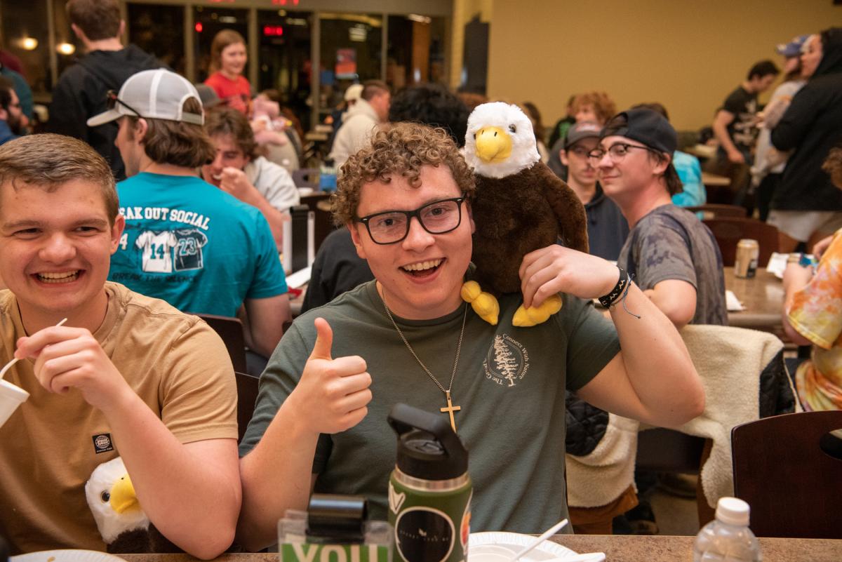 On the wings of an eagle: Brian P. Foley flies into Finals Week, offering his new friend a shoulder to perch on. Foley is a freshman in building construction technology from Newtown Square.