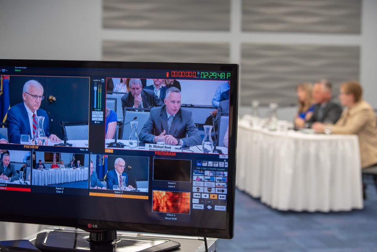 The testimony of President Reed (on screen, top right) is livestreamed by state Senate Republicans during Wednesday's on-campus hearing; Sen. Yaw is visible at left on the webcast monitor. 
