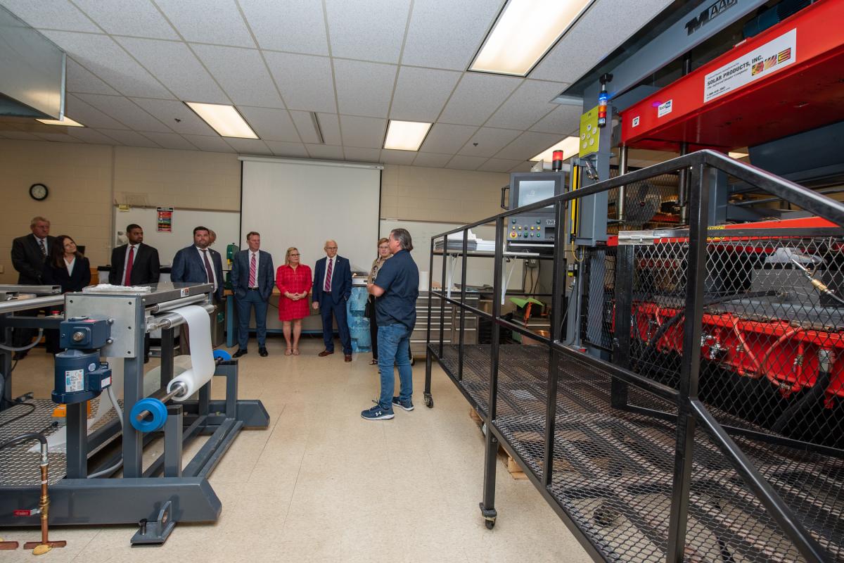 Christopher J. Gagliano, Plastics Innovation & Resource Center project manager, enlightens guests in the college's 1,800-square-foot Thermoforming Center of Excellence – an impressive part of any campus visit.