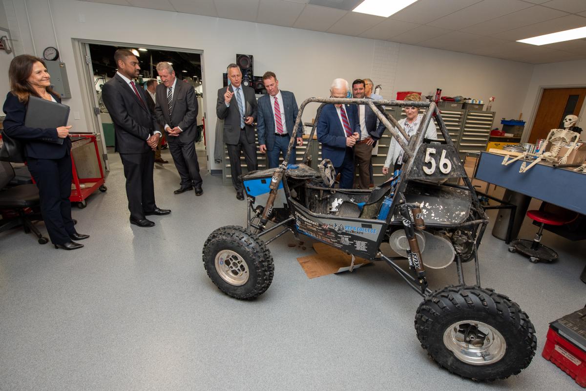Laughlin and Co. get a peek at the student club's all-terrain vehicle in the newly dedicated Penn College Baja Room. The committee chairman's curiosity was piqued by mention of the Baja car during Reed's testimony.