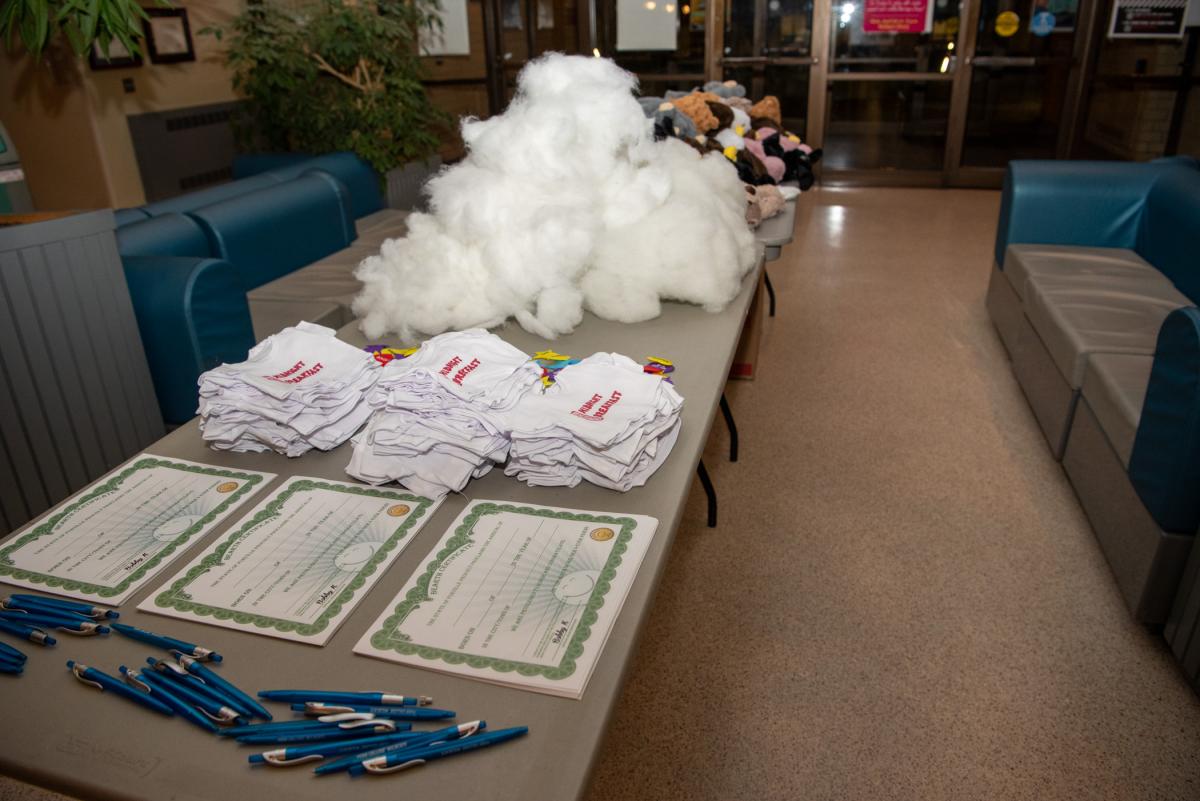 Awaiting early arrivals: a table full of “stuffies” in a variety of animals that also received their own mini-sized Midnight Breakfast T-shirts and their own “bearth” certificates.