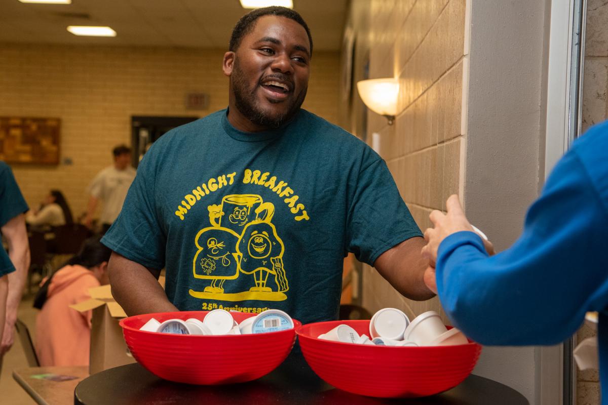 Enthusiastically distributing ice cream is Nate Woods Jr., special assistant to the president for inclusion transformation.