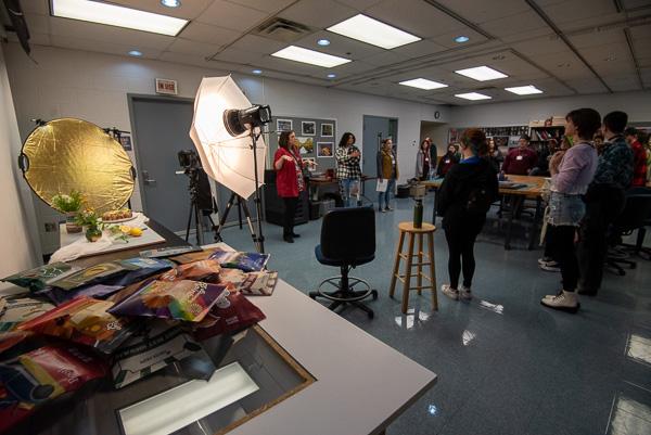 In the commercial photography studio, instructor Joanna K. Yoder (at center in red) encourages exploration ...