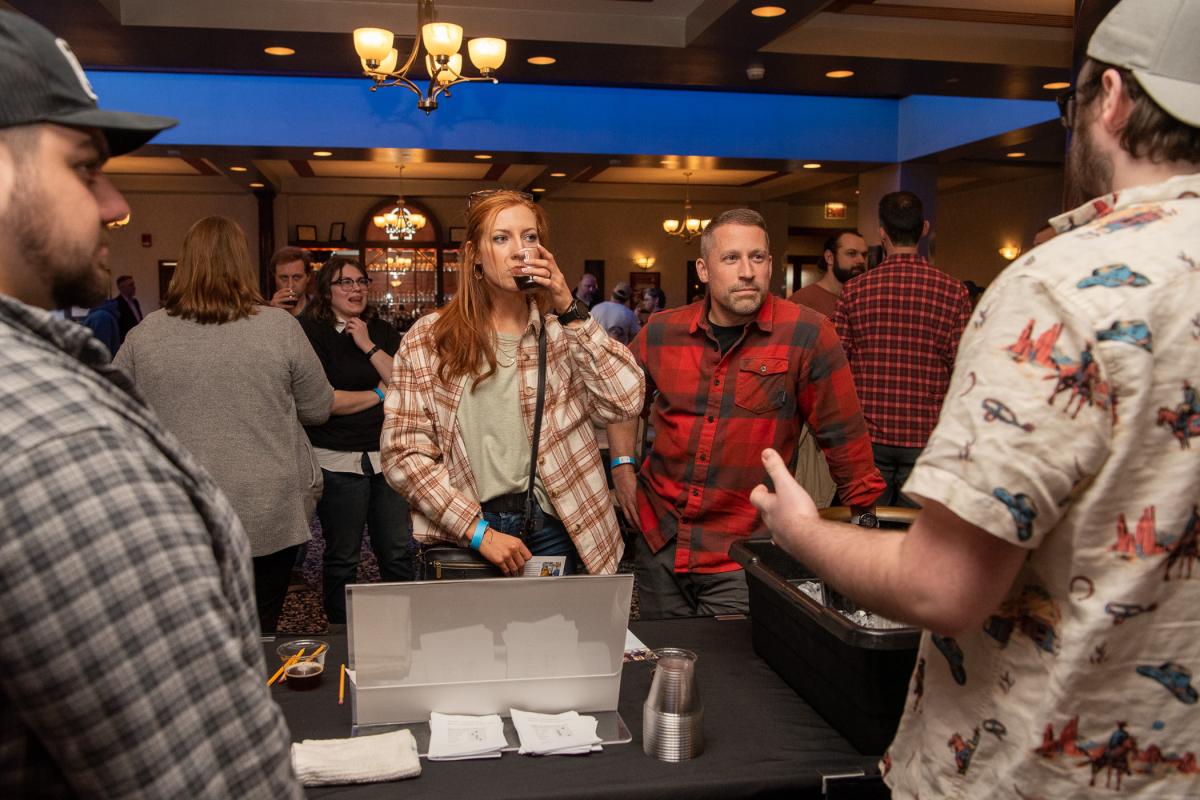 Another incoming brewing student, Devin Smith (tasting) and husband, Bryan, listen to students share their experimentations. The Smiths own Clarion River Brewing Co., in Clarion.