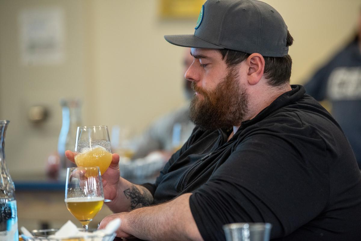 Alumnus Christopher P. Good, ’19, brewing & fermentation science, considers a sample. Good is the innovation manager for Victory and Sixpoint Brewing Cos.