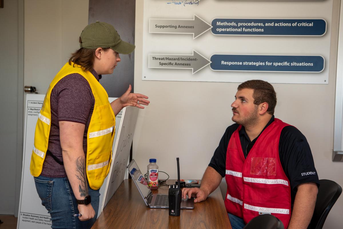 Emergency management & homeland security students Ashley Thoirs-Lawrence, logistics, and Michael J. Gruber, operations section chief, converse. Thoirs-Lawrence resides in Williamsport; Gruber is from Rockville, Md.