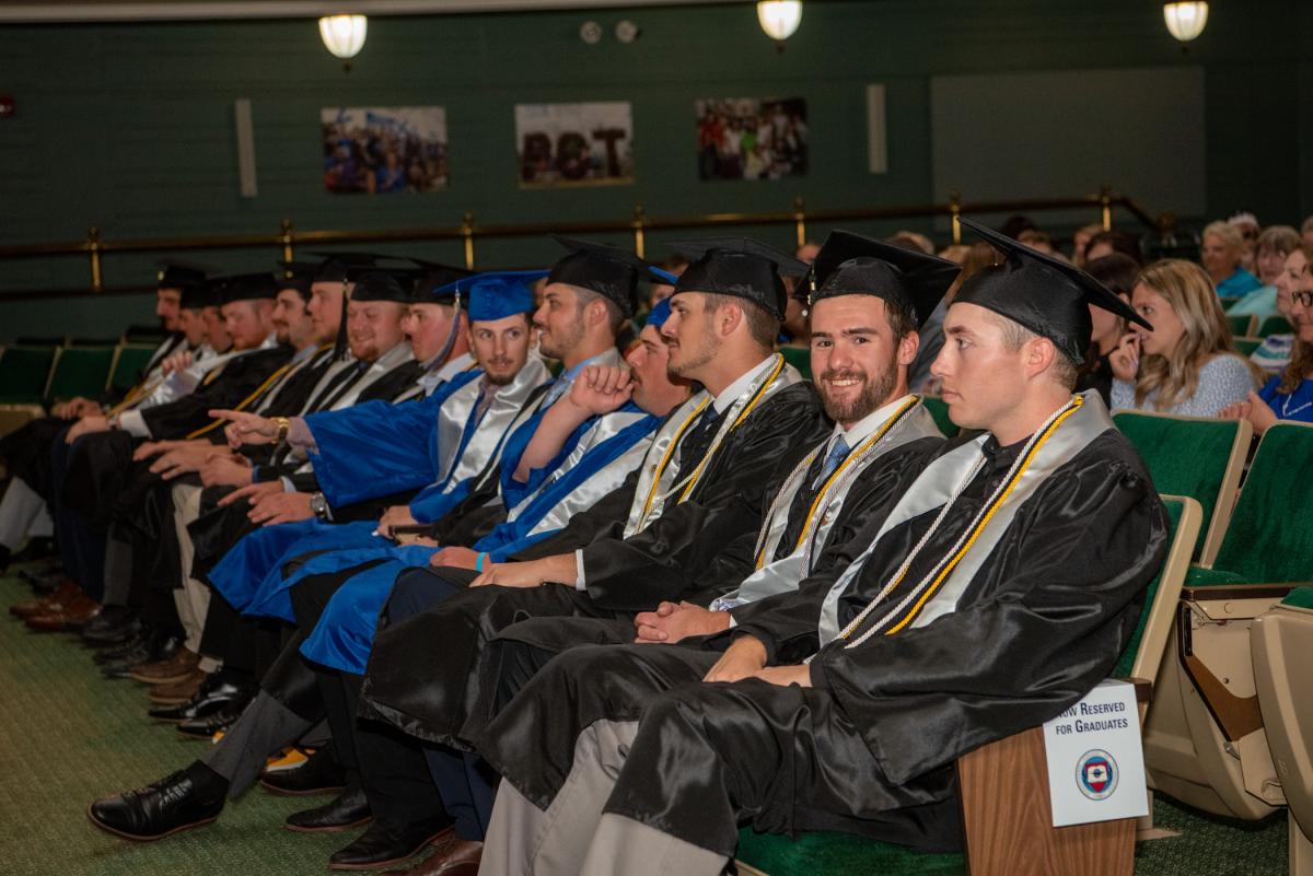 Jacob E. Carles (looking at the camera) and teammates enjoy the front-row treatment befitting their all-star status as college graduates.