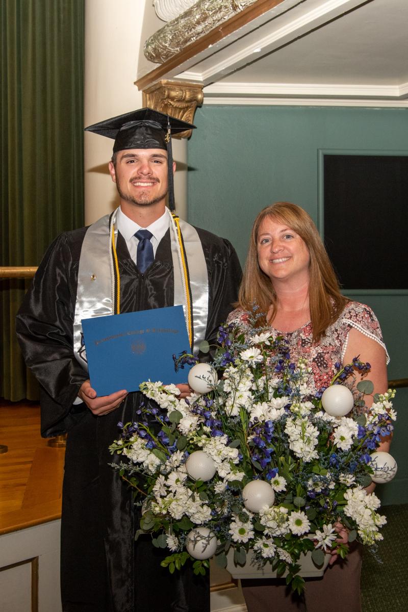 Cole A. Culver with his mom, holding the themed bouquet that was spontaneously handed over at night's end by coach Howard