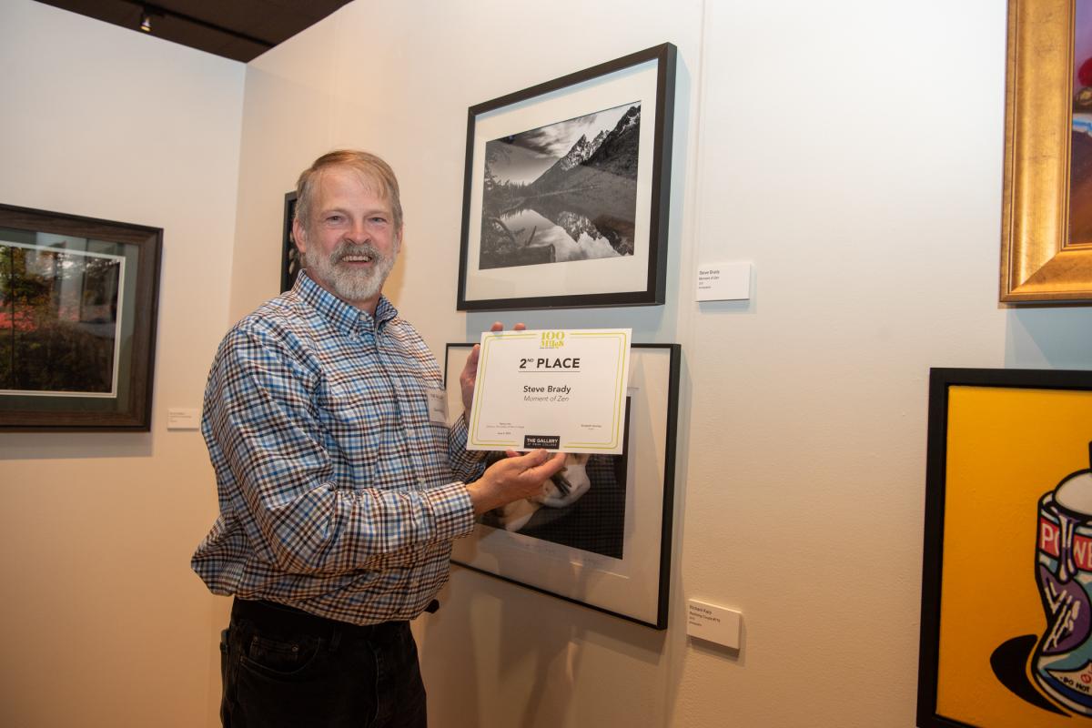 ... and second-place recipient Brady with his winning photograph, among three on display.
