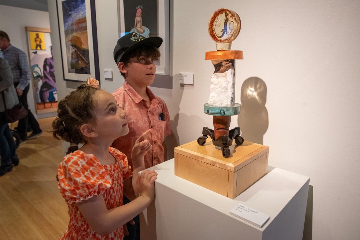 Youngsters are intrigued by Denis A. Yanashot’s sculpture, “Upward Mobility.”