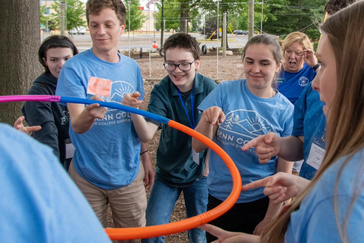 The hoop takes some upward detours on its way to the ground, eliciting good-natured fun.