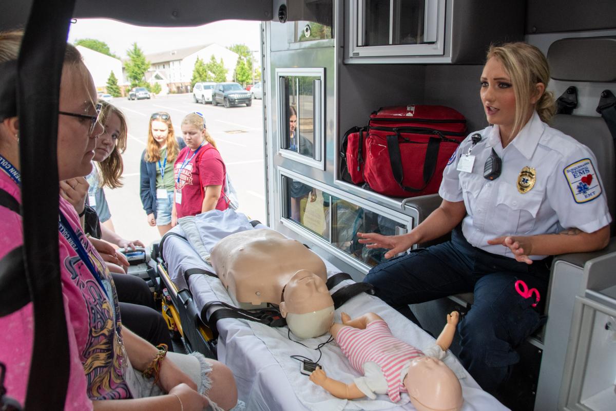 Campers check the inside of an ambulance ...
