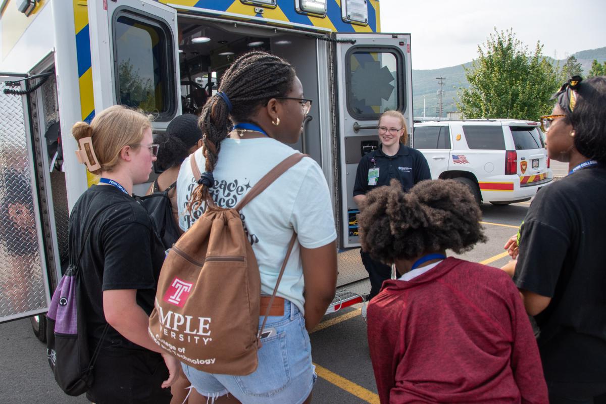 ... while outside, Breyanne E. Johnson, a Penn College paramedic science student from Danville, talks a group through the functions of a heart monitor.