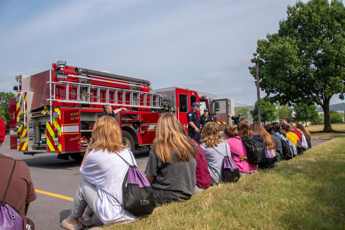 Lt. Ken Smith, of the Williamsport Bureau of Fire, talks with Health Careers participants behind the library.