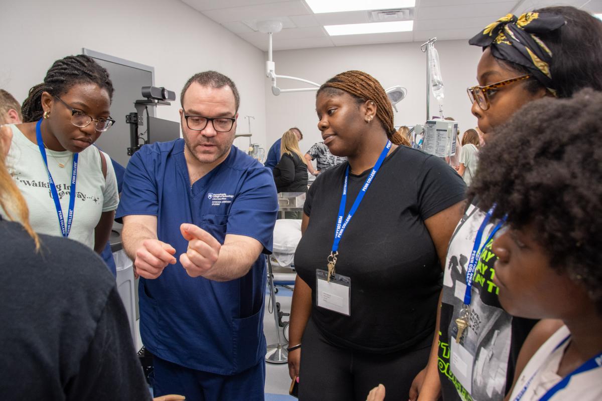 A physician assistant student shows the tip of an intraosseous drill, used in emergency medicine.