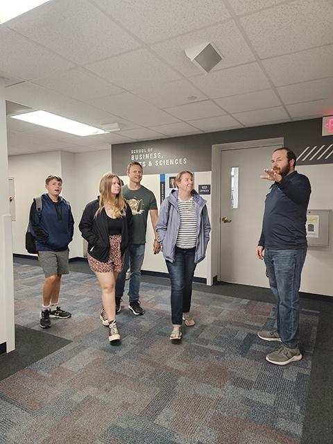 Kyle W. Kern, coordinator of student success, directs a family to its Klump Academic Center destination.