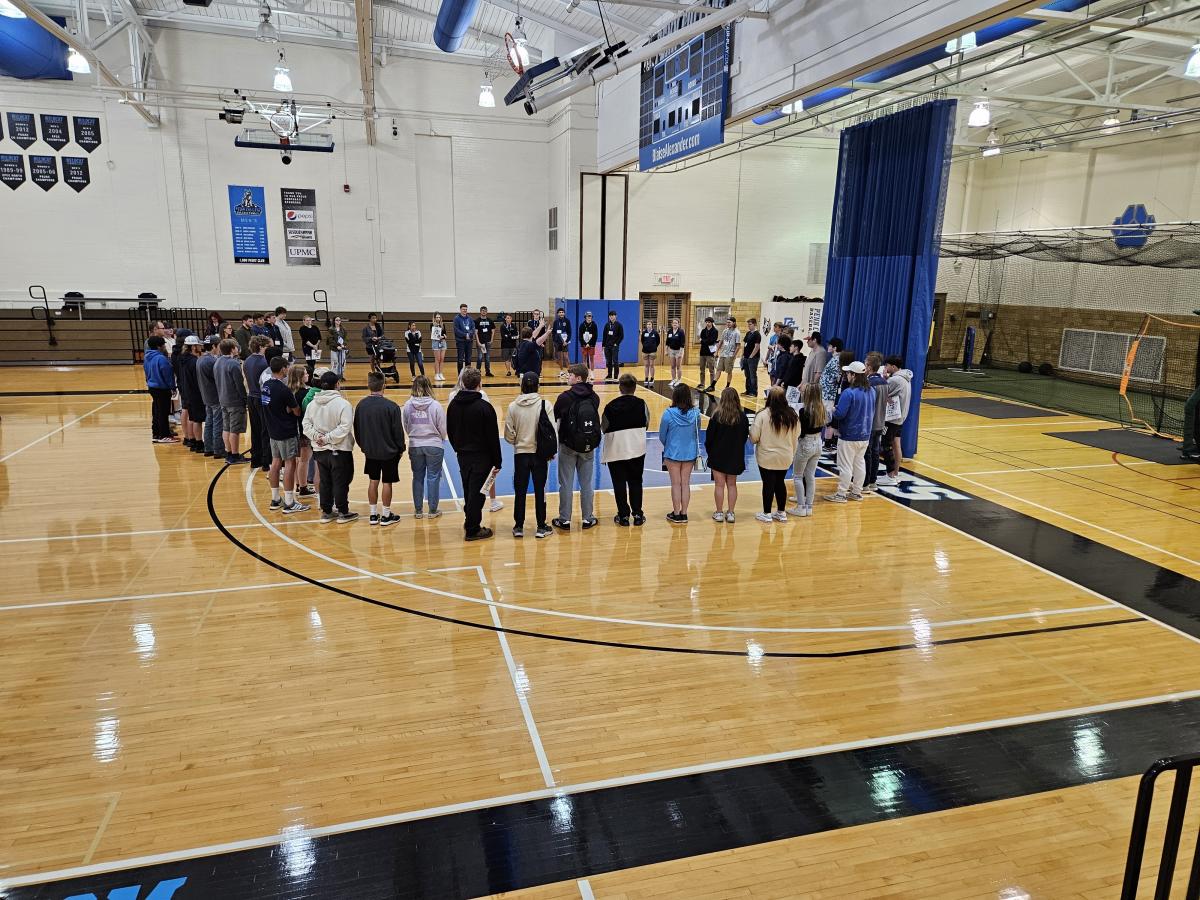 Incoming students form a circle for a Bardo Gym session espousing "the Wildcat Way" ...