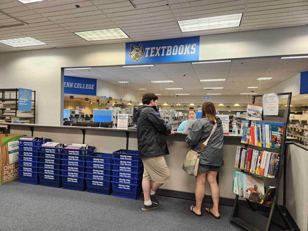 ... where Heather R. Harris, part-time textbook merchandise assistant, assists a family.