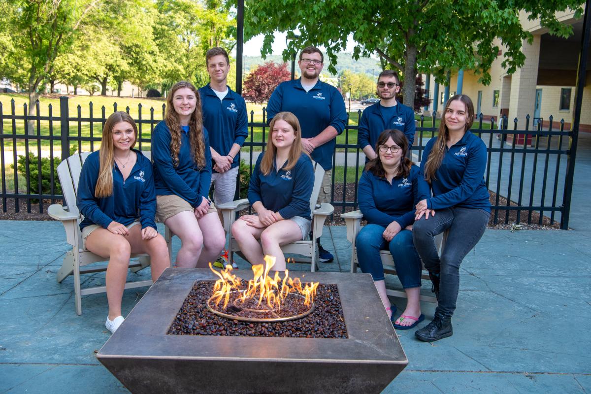 Weeks before the start of summer, the student members of Penn College's orientation team were fired up to assist new classmates and their families. Photographed on the Bush Campus Center Patio earlier this month are (counterclockwise from front left) orientation leaders Kylee P. Albert, Christie R. Baldwin, Eryn L. Nichols, Savannah J. Zook, Hayden D. Lester, Nando J. Ubaldini and Kellor A. Schooley; and orientation intern Maverick C. Stenger, pursuing a master's degree at Slippery Rock University. (Photo b