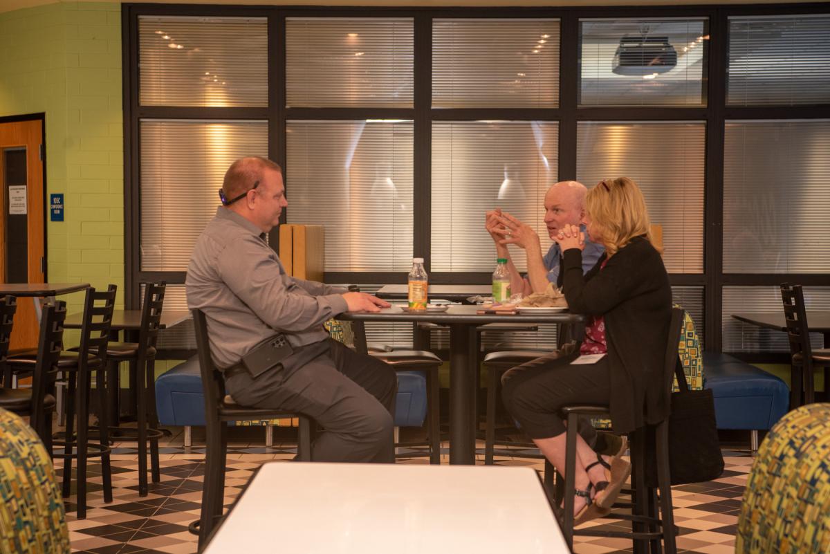 Jeff L. Rankinen (back right), associate professor of electronics, socializes with guests during lunch in CC Commons.