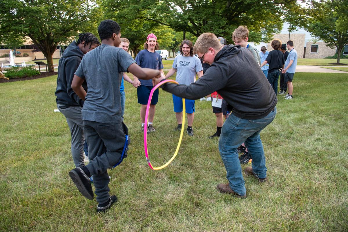 A different type of “wheel” for the automotive crew! As part of their early-week networking, the young visitors engage in team-building exercises like this one, where they pass a hula hoop over their bodies without “breaking” the circle. This takes a lot of head-to-toe movement and coordination!