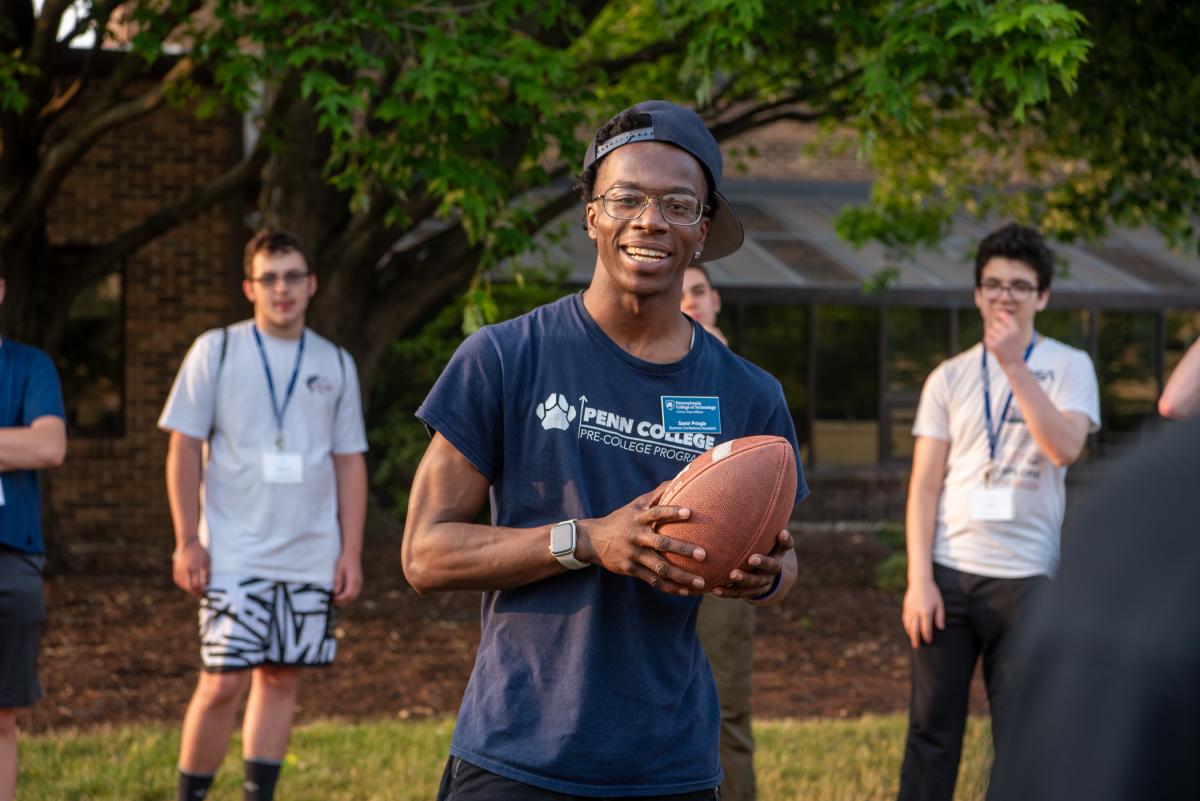 A master at stirring connections and humor, Samir K. Pringle, a summer conference assistant, facilitates a getting-to-know-you session for the campers. Pringle is a business administration student. 