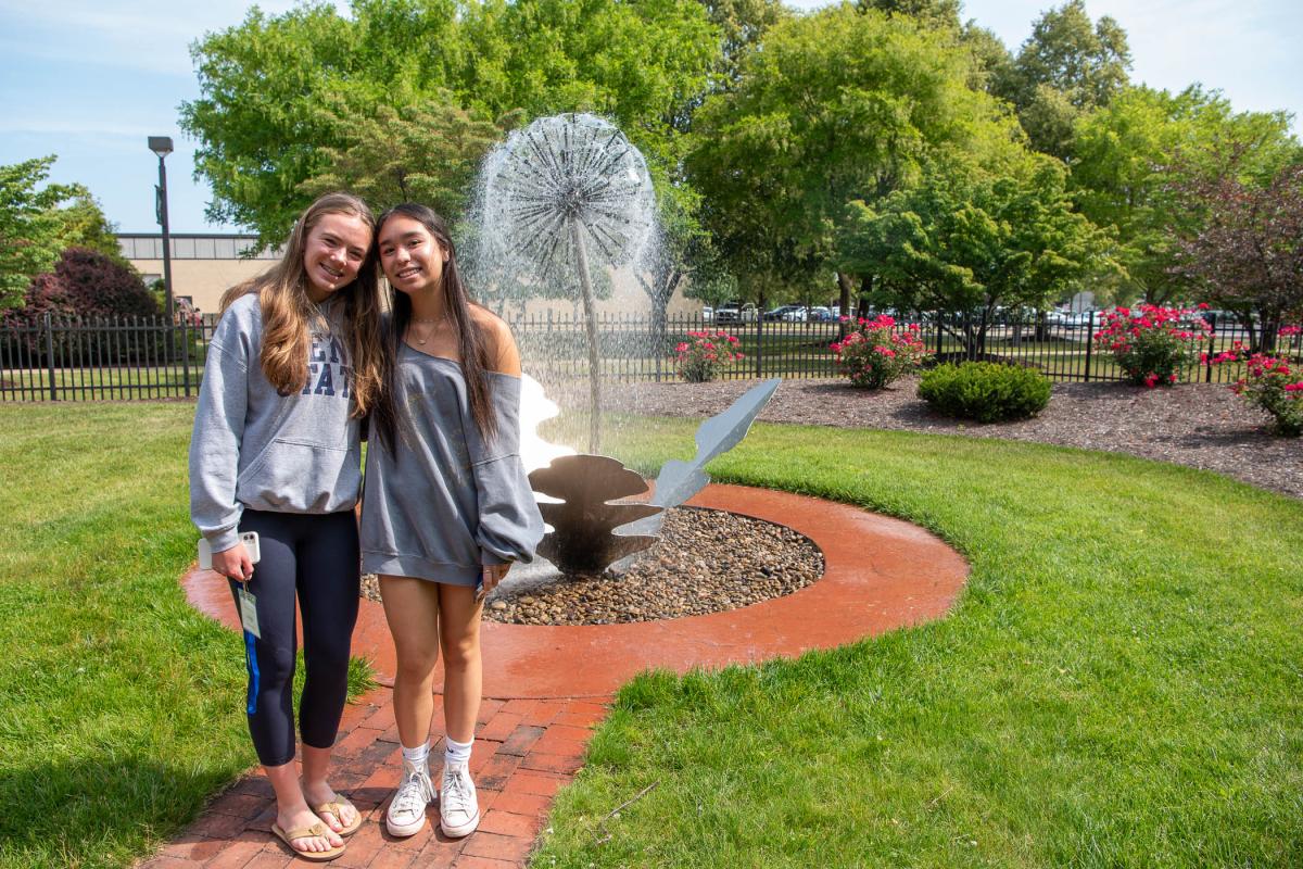 On the grounds of The Victorian House, the dandelion water feature offers a perfect photo op for these two high school friends from Maryland. 