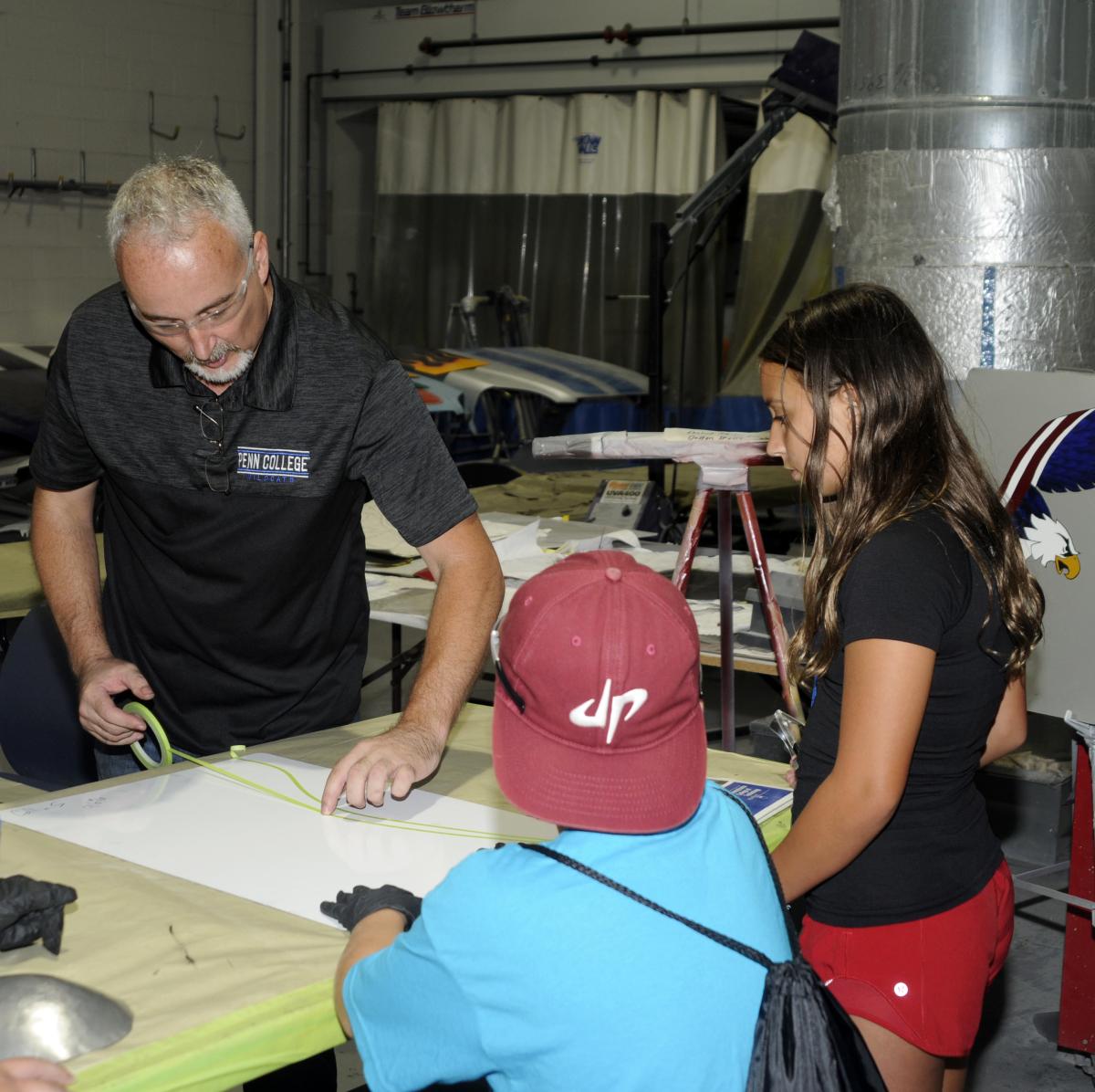 Near the program's College Avenue Labs paint bay, Klinger neatly pinstripes a flame design.