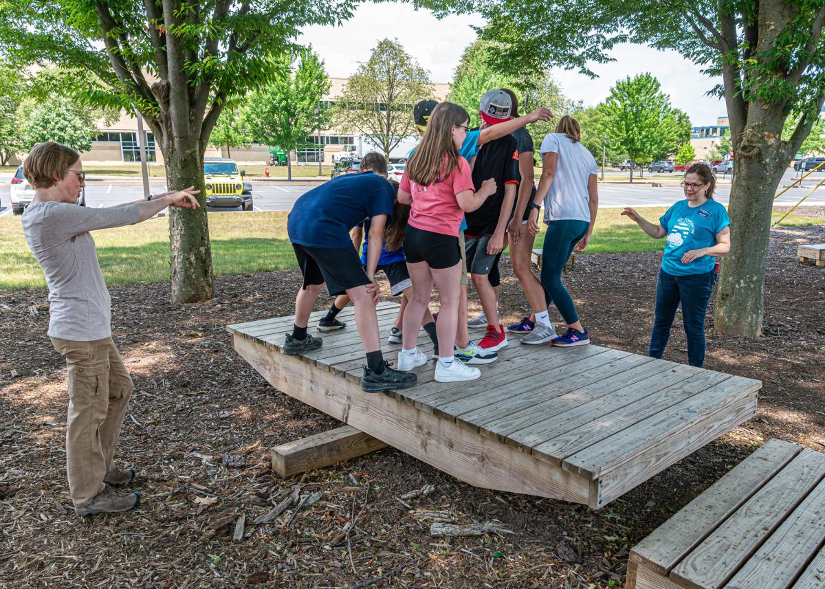 Youngsters attain balance with the aid of Kat A. Valentine (left), manager of makerspace operations, and Kathleen V. McNaul, assistant director for student success.