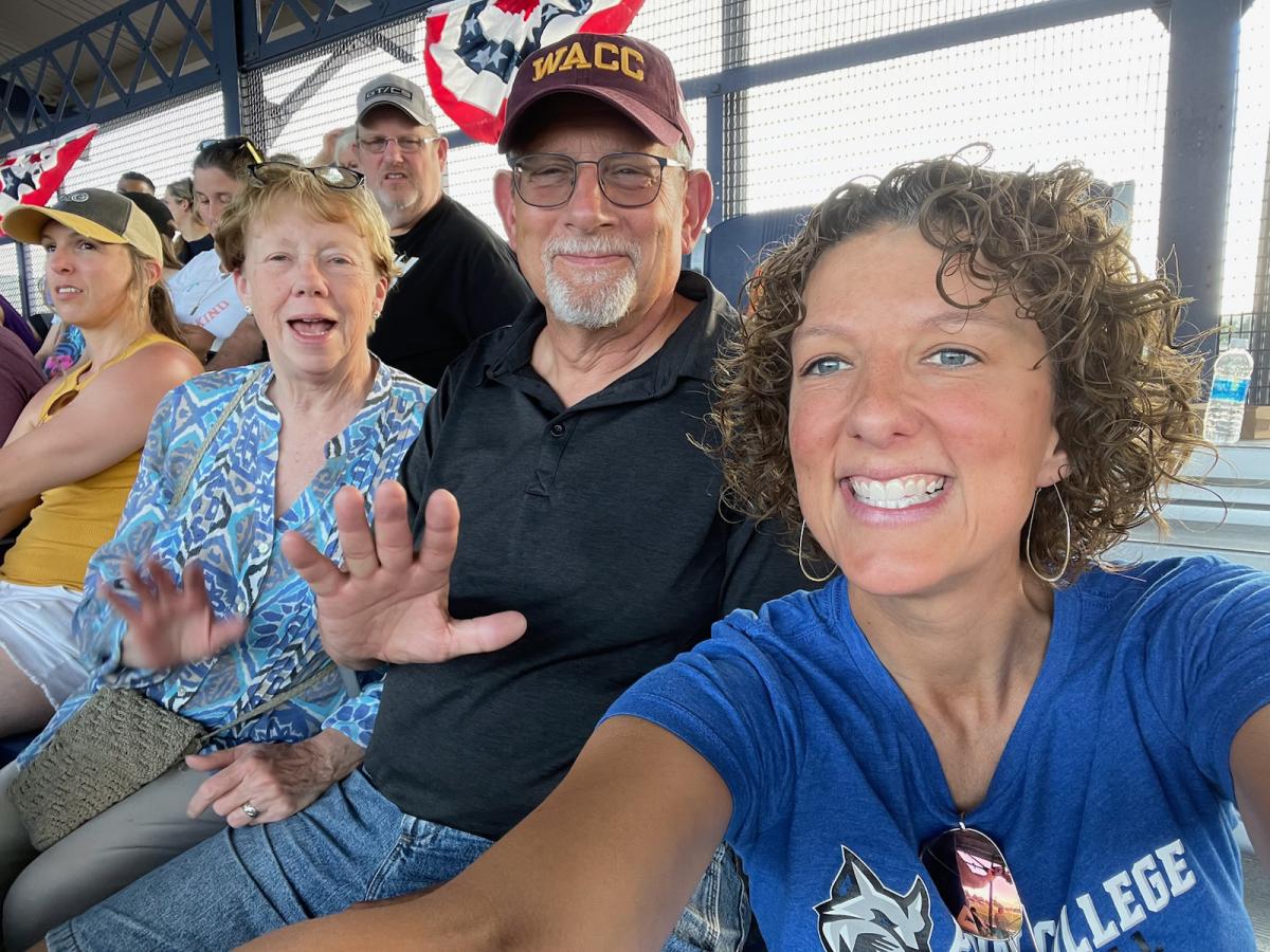 Kimberly S. Cassell (right), college relations director, takes an in-the-stands snapshot with Janice and John Urick. John is a 1974 forest technology grad of Williamsport Area Community College, as proudly reinforced by his choice of headgear.