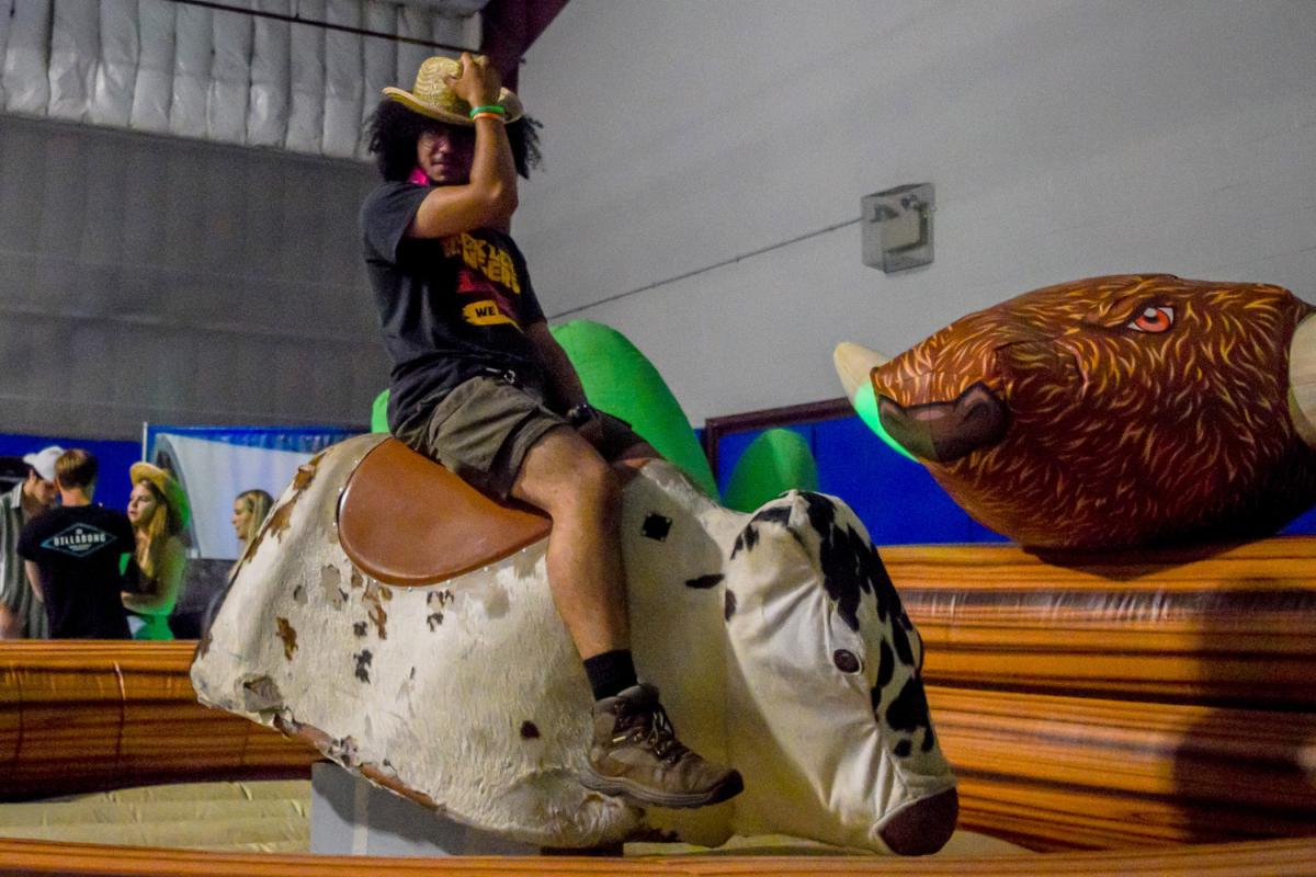 A tip of the hat with one hand and hanging on tightly with the other, a rider chases a thrill.