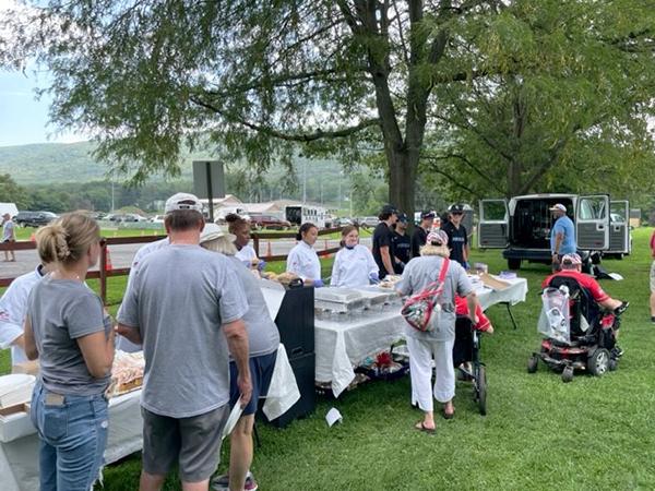 Picnickers move through the serving line.