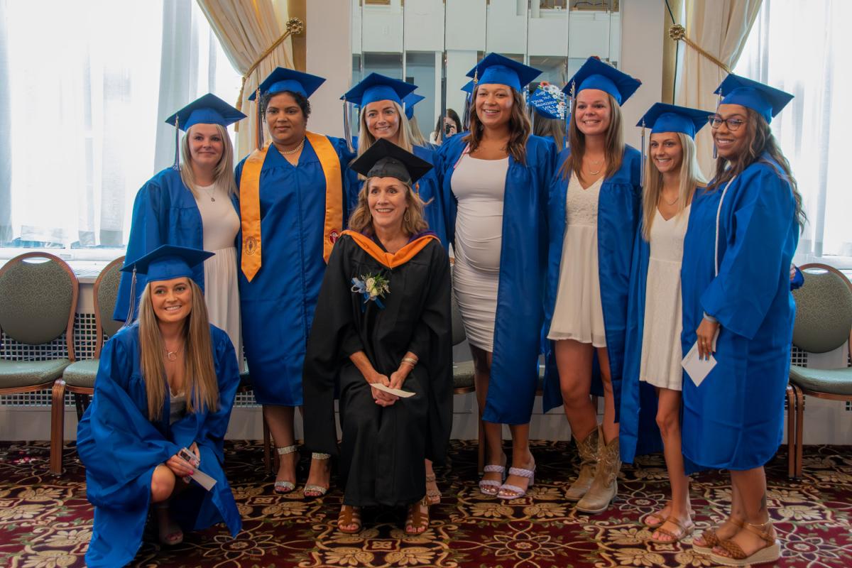 And the final graduating class from the college’s associate degree in practical nursing, joined by assistant professor Sherry L. Hyland (in black).