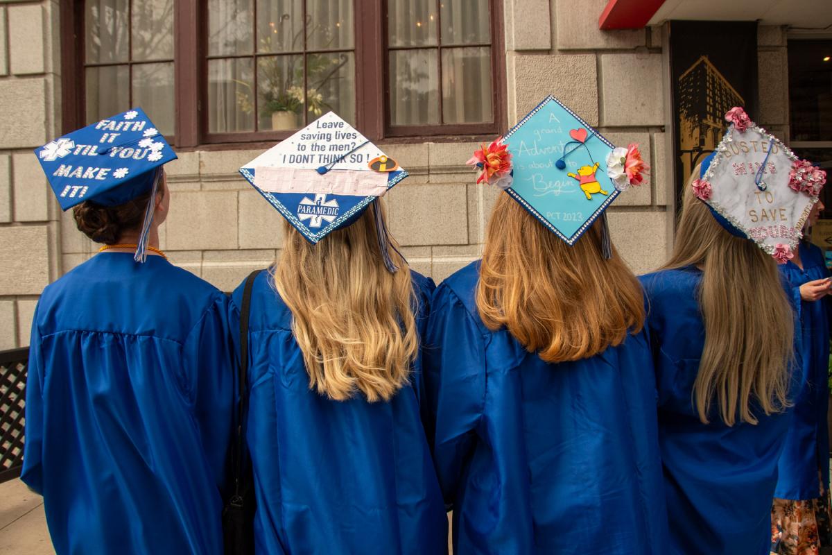 A group of paramedic program grads shows off its fun and inspiring headwear.