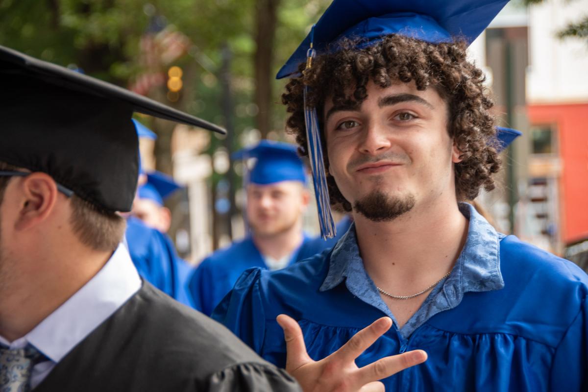 Zachary B. Smith, of Chester Springs, acknowledges the camera as he enters the Community Arts Center. Smith earned a degree in heating, ventilation & air conditioning technology.