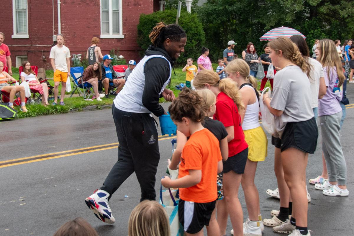 David Brown, a Wildcat basketball player majoring in business administration: sport and event management concentration, cheerfully obliges fans’ requests for trading pins.