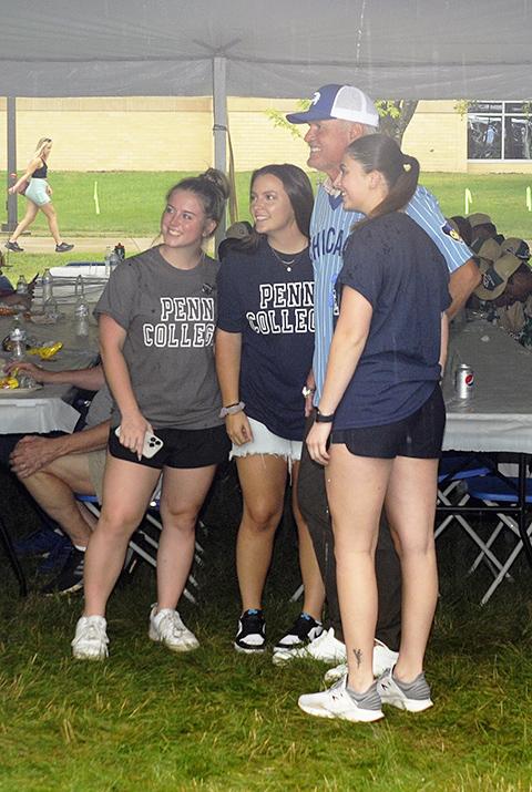 Volunteers from the women's softball team snag a photo with Sandberg. From left are Colleen V. Cole, of Danville, pre-dental hygiene; Ivvy R. Morder, of Mechanicsburg, accounting; and Madison J. Herriman, of Danville, nursing. They – along with their coach, Angela L. Stackhouse – each accompanied a team during the picnic.