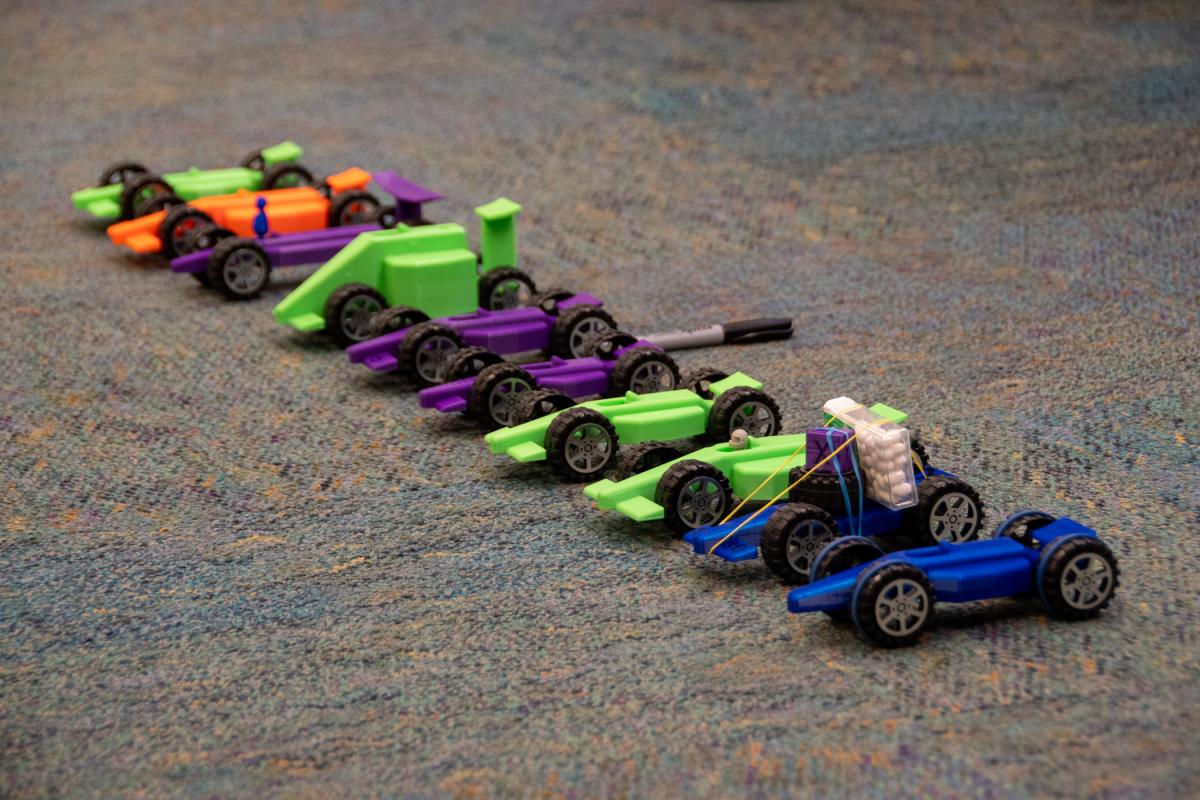 Nine 3D-printed cars “pose” before a final-day race begins.