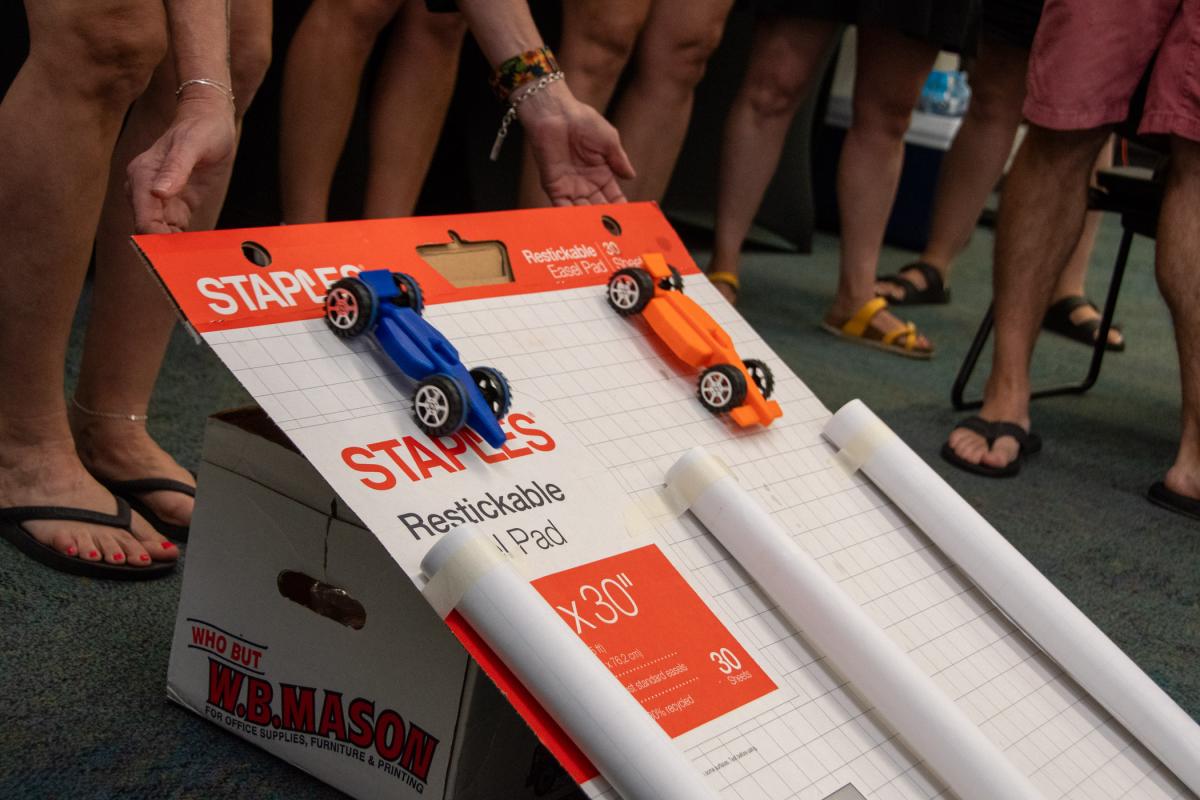 Vehicles are released. They competed for fastest speed and longest distance traveled. The activity was one sample the teachers could take back to their classrooms.