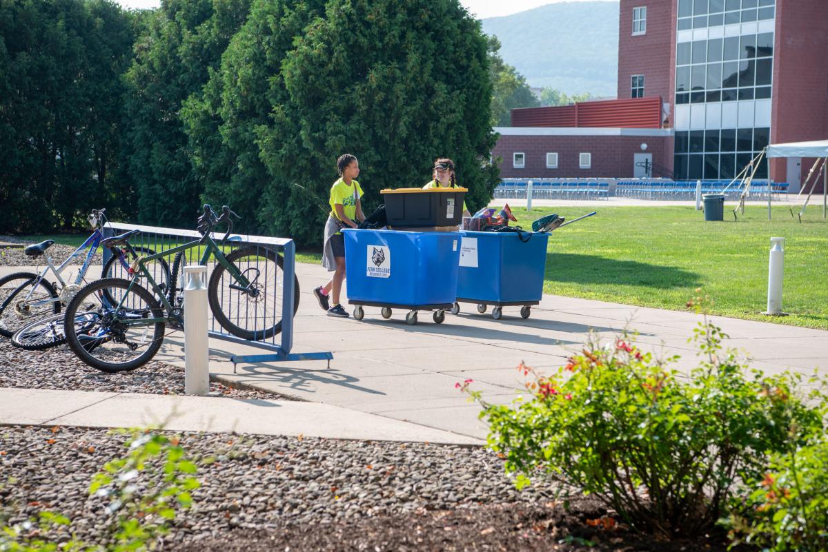 As they roll along, move-in volunteers enjoy ample time for conversation. Among the variety of necessities being toted: a fishing pole, potato chips and floor-cleaning supplies!