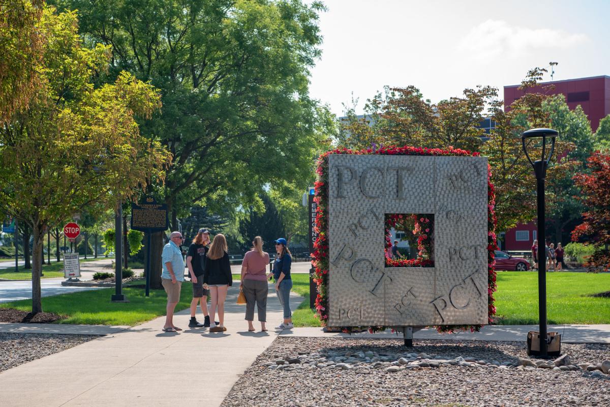 Admissions Counselor Stephanie A. Golder (in blue hat) offers friendly support to a family.